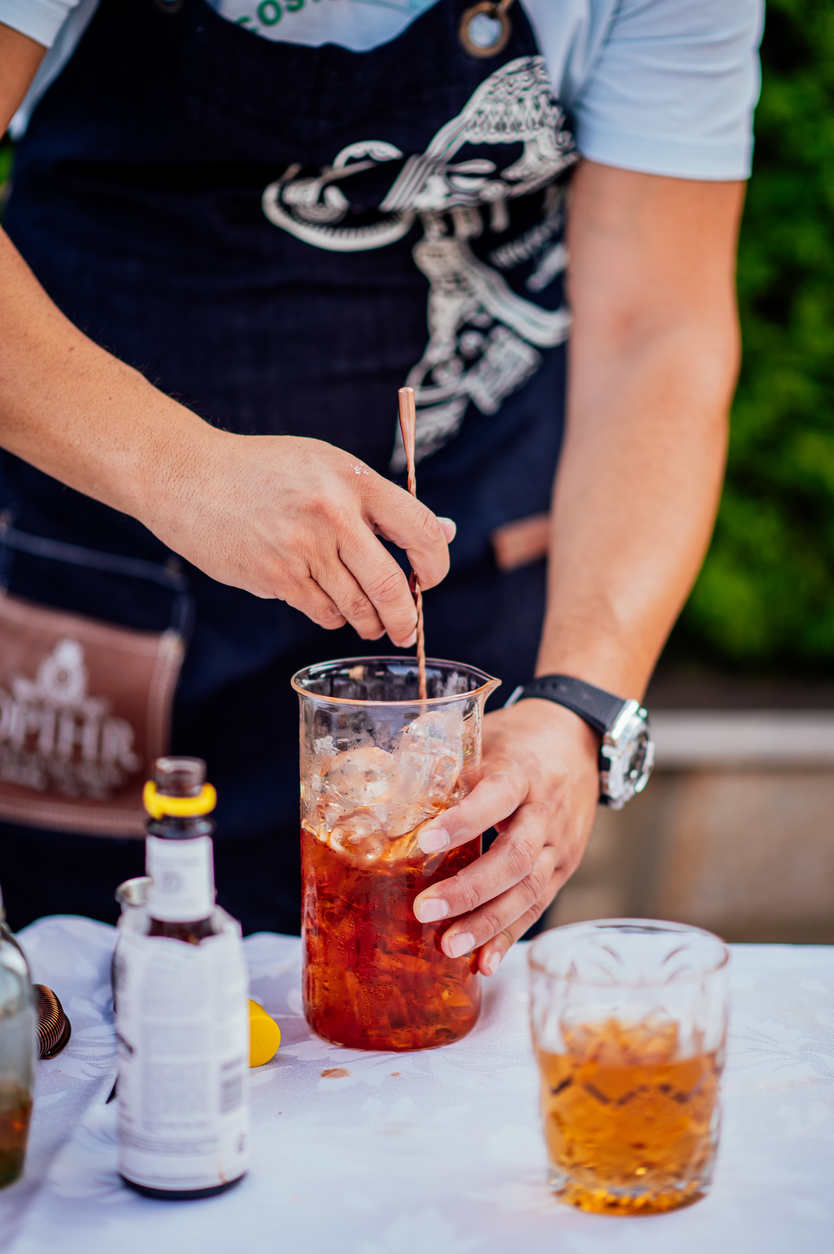 The bartender preparing a cocktail