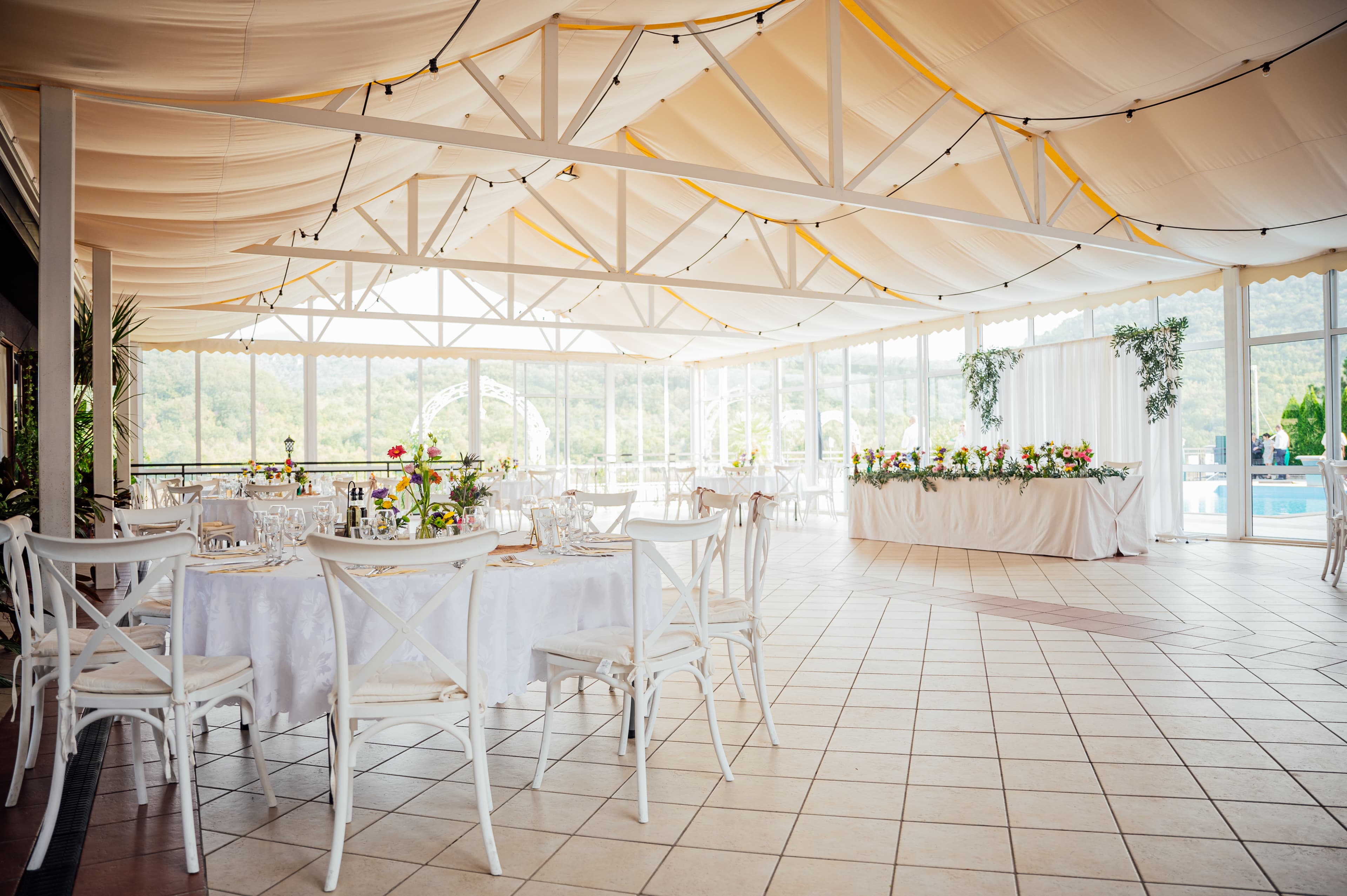The marquee laid for dinner overlooking the pool